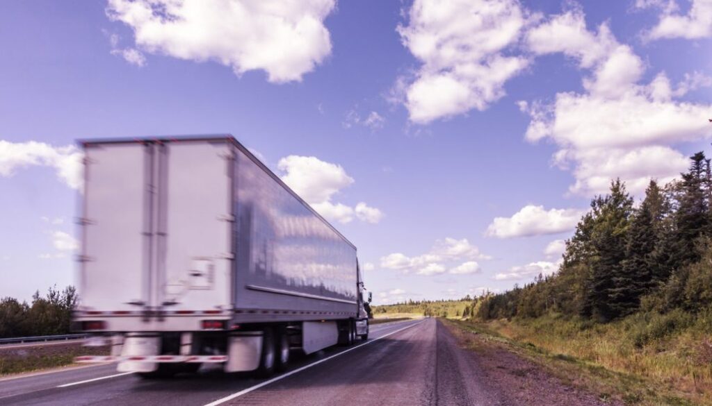 Canadian Highway Semi Tractor Trailer Truck Streaking Past