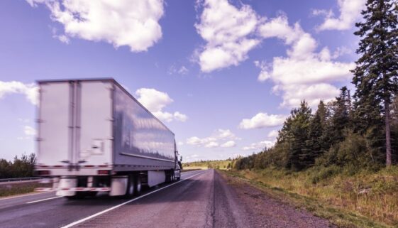 Canadian Highway Semi Tractor Trailer Truck Streaking Past
