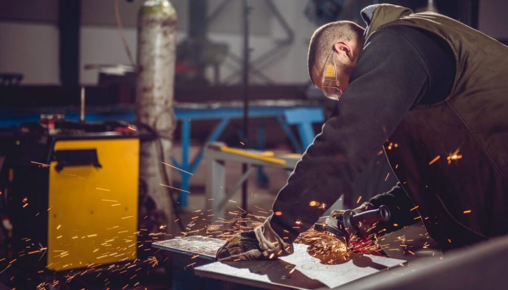 Worker Using Angle Grinder