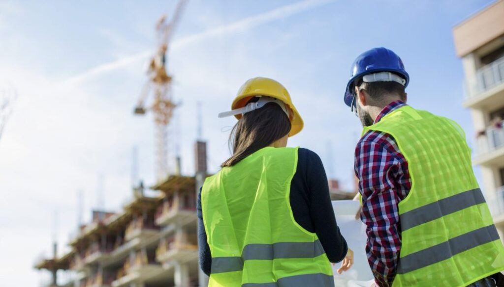 Construction worker and his manager checking the progress