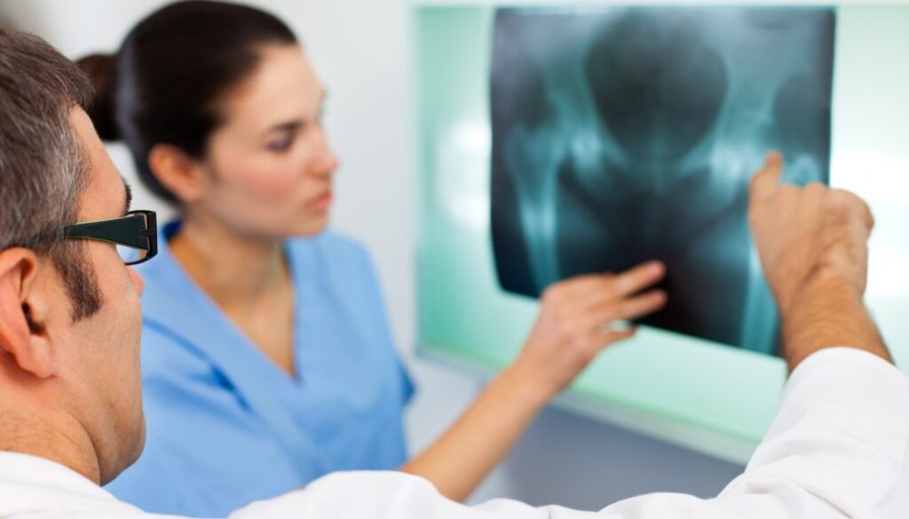 Doctor looking at X-ray image of a pelvis