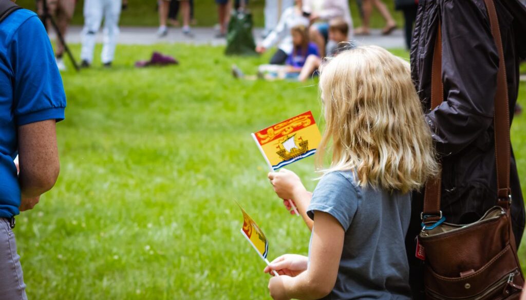 Officials with the city and the provincial government handed out small New Brunswick flags like this one to those in attendance. Image: Aaron Sousa